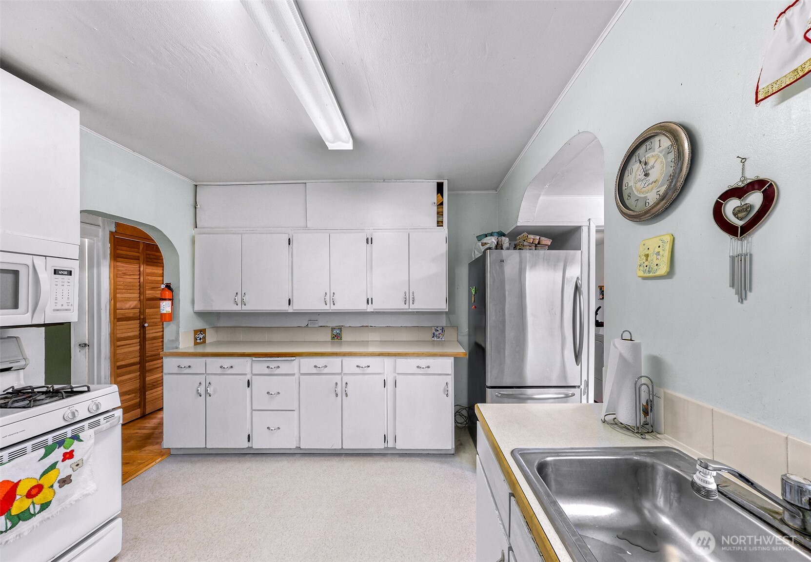 4610 Curtis Road Bellingham, WA 98226 - Photo 24 of 34 a kitchen with stainless steel appliances granite countertop a sink a stove a refrigerator a washer and dryer