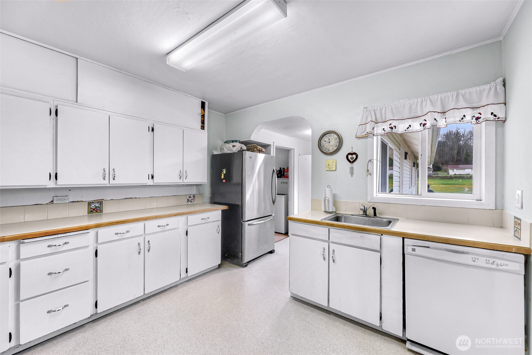4610 Curtis Road Bellingham, WA 98226 - Photo 29 of 34 a kitchen with white cabinets and white appliances