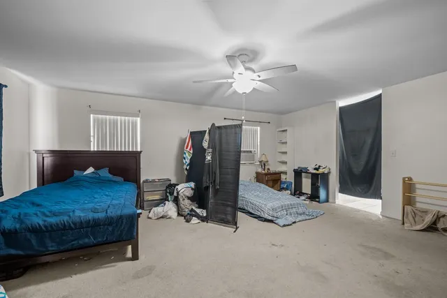 a bathroom with a granite countertop sink mirror vanity and bathtub