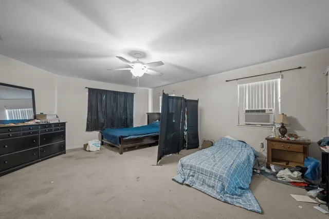 a bathroom with a toilet sink vanity and mirror