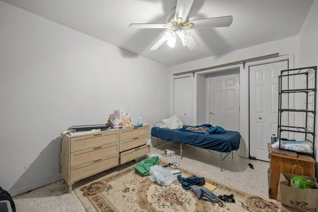 a bedroom with a bed and a view of walk in closet