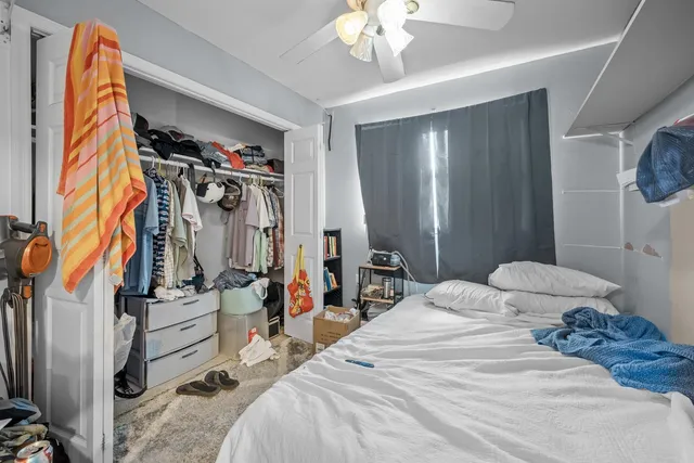 a bedroom with a bed and flat screen tv