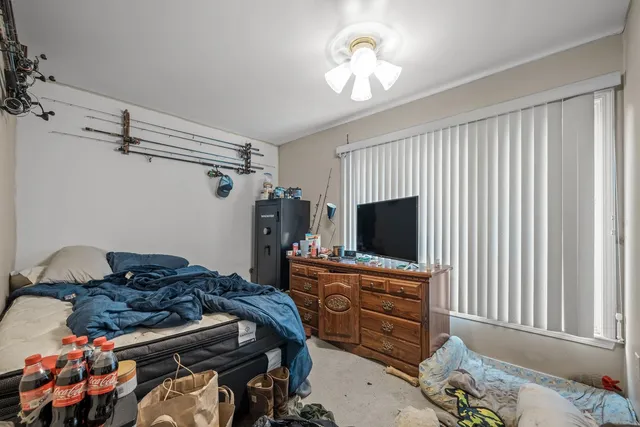 a backyard of a house with table and chairs wooden floor and fence