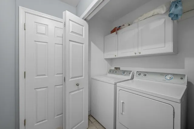 a view of a chair and table in backyard of the house