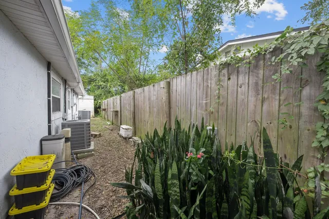 a view of a backyard with large trees and plants