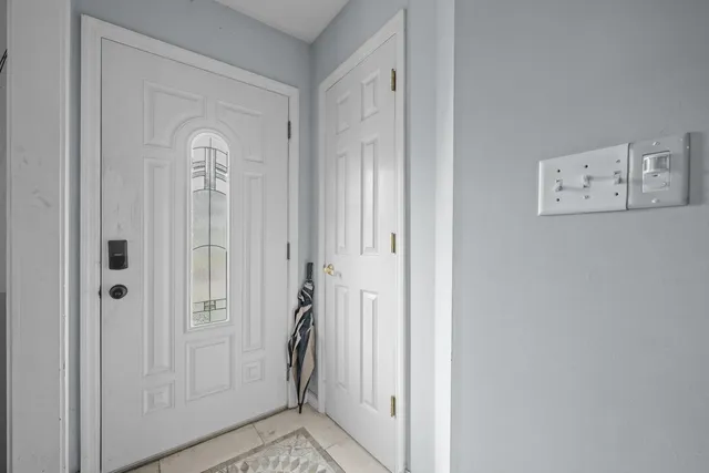 a view of a dining room and livingroom with furniture wooden floor a chandelier