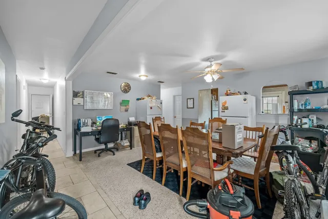 a view of a dining room with furniture and chandelier