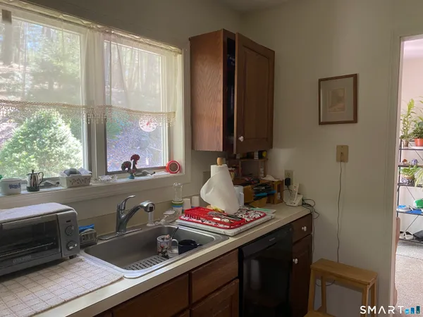 a kitchen with a sink and a stove next to a window