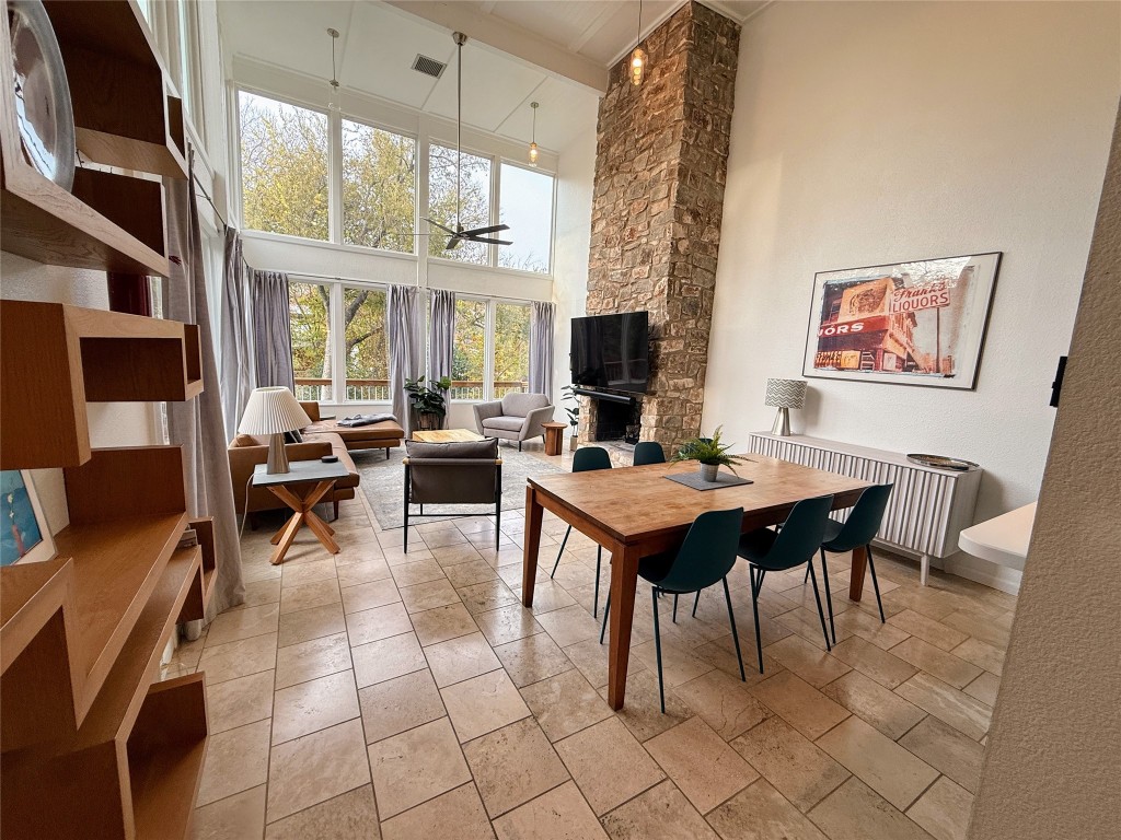Undisclosed Address Austin, TX 78746 - Photo 1 of 26 a living room with furniture a fireplace and a large window