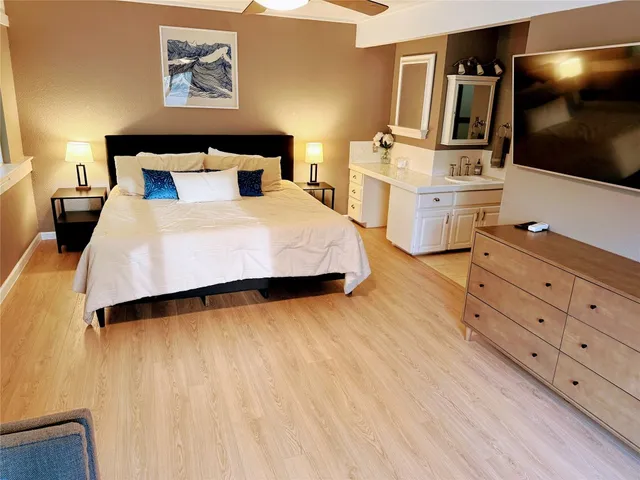 a bedroom with a bed and flat screen tv