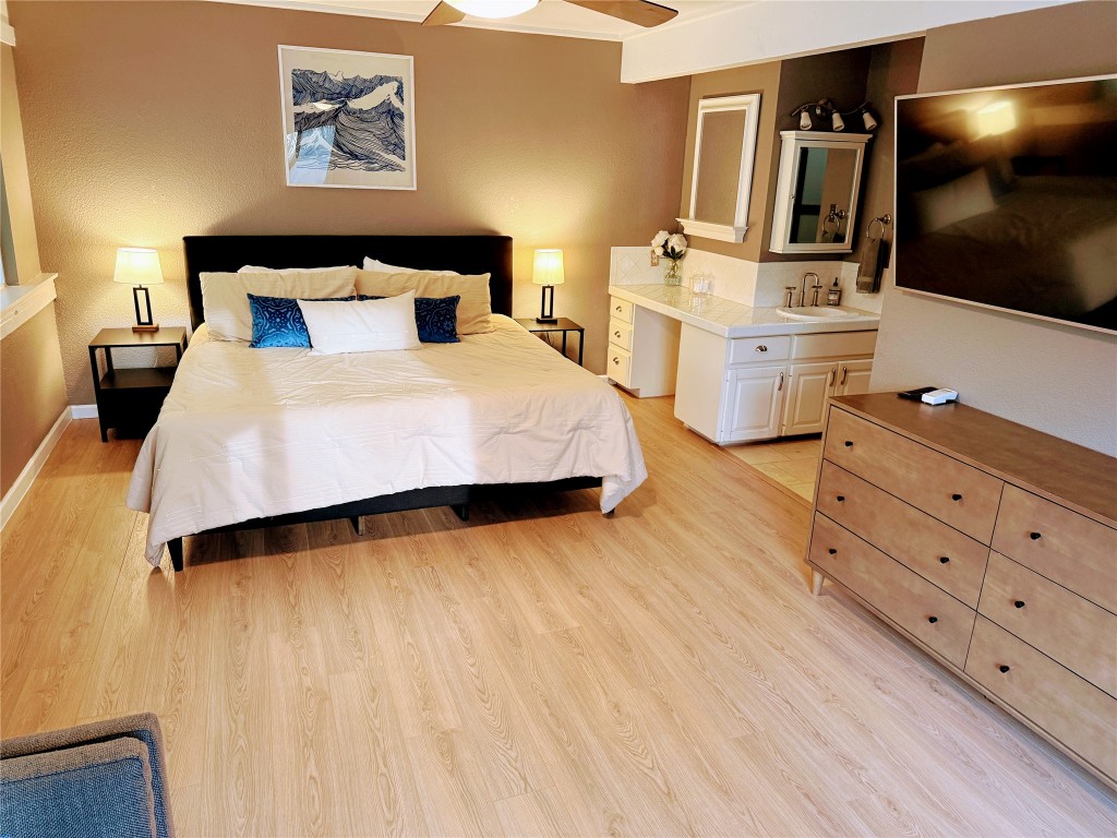 Undisclosed Address Austin, TX 78746 - Photo 13 of 26 a bedroom with a bed and flat screen tv