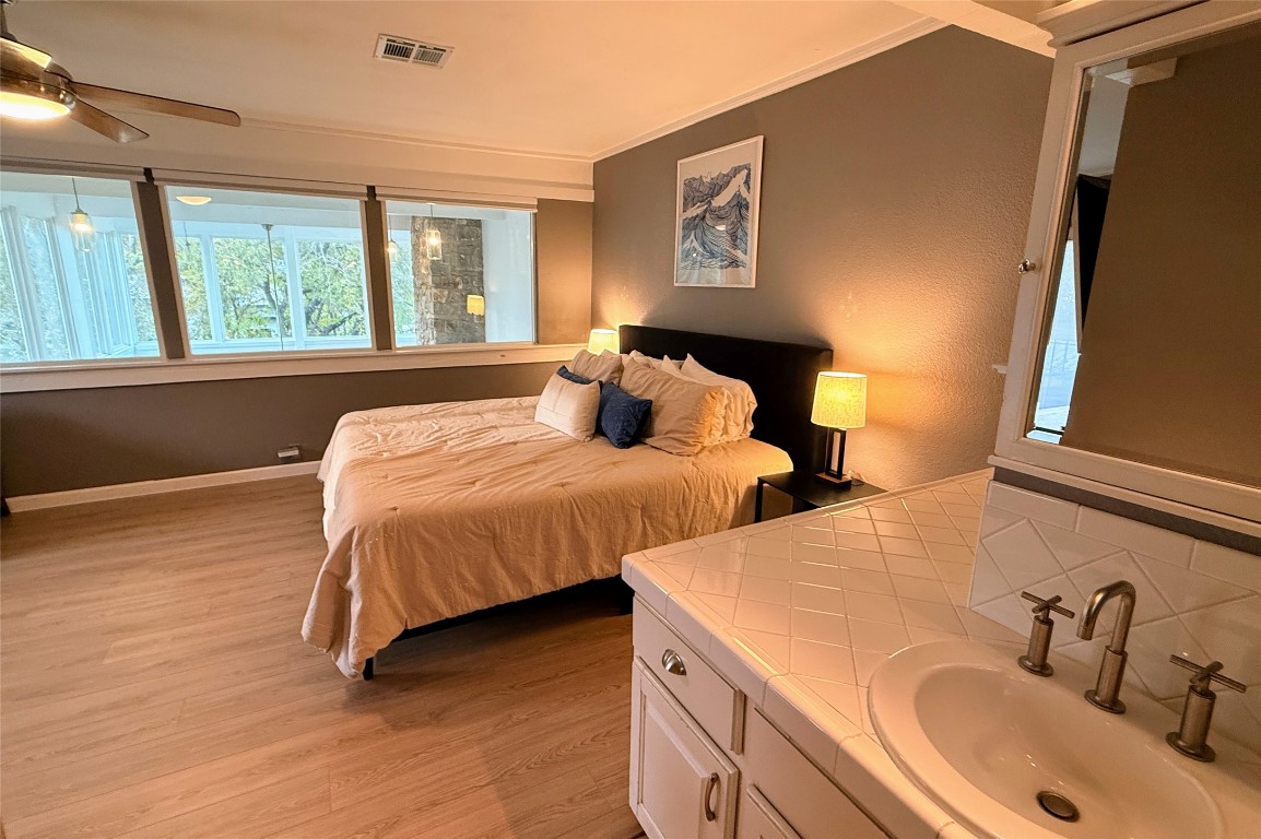 Undisclosed Address Austin, TX 78746 - Photo 15 of 26 a bedroom with two beds and a dresser next to a window