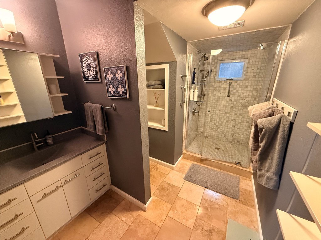 Undisclosed Address Austin, TX 78746 - Photo 18 of 26 a bathroom with double vanity and a shower