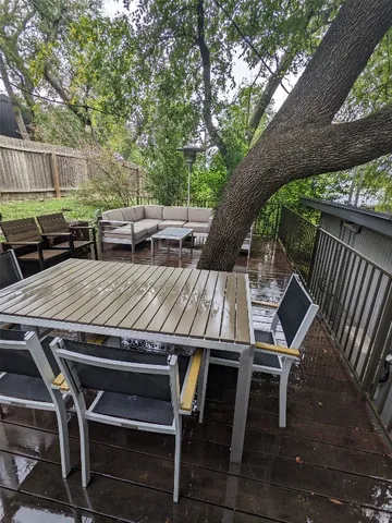 a view of backyard with deck and wooden floor