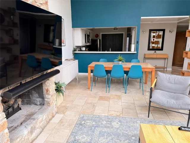 a living room with chairs and a flat screen tv