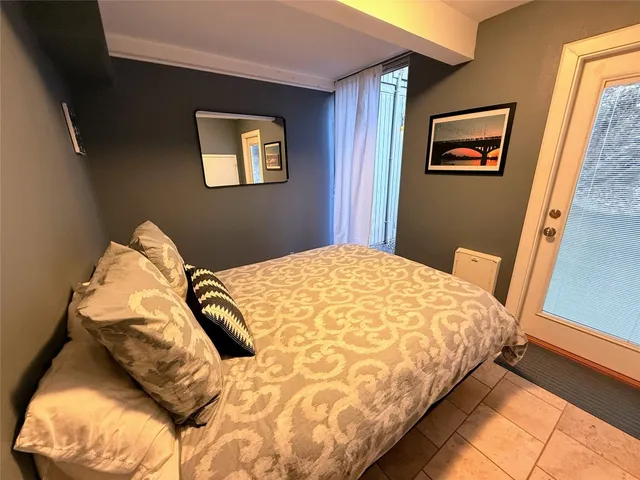 a bedroom with a bed and a painting on the wall