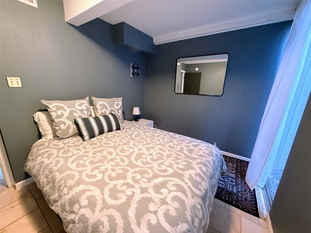 Undisclosed Address Austin, TX 78746 - Photo 10 of 26 a bedroom with a bed and a painting on the wall