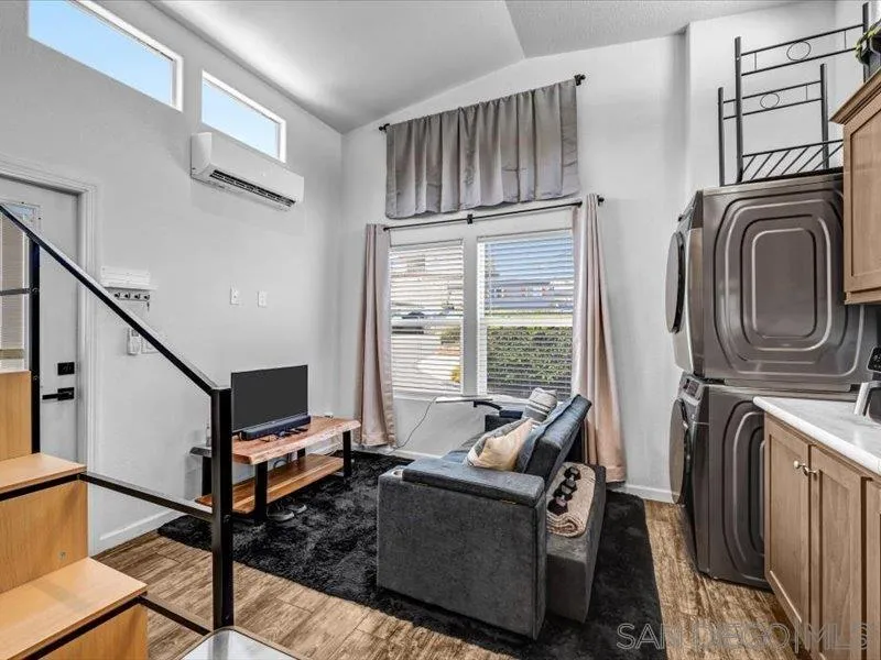 14291 Rios Canyon Road, Unit 3 El Cajon, CA 92021 - Photo 10 of 16 a living room with furniture a flat screen tv and a window