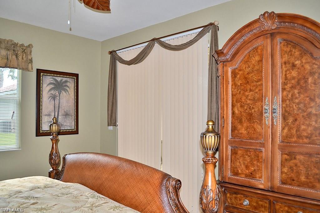 4007 Recreation Lane Naples, FL 34116 - Photo 13 of 24 a bedroom with a bed and a mirror