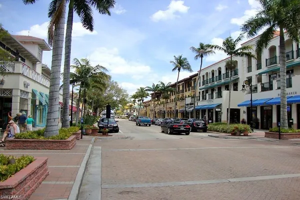 a city street lined with buildings and trees