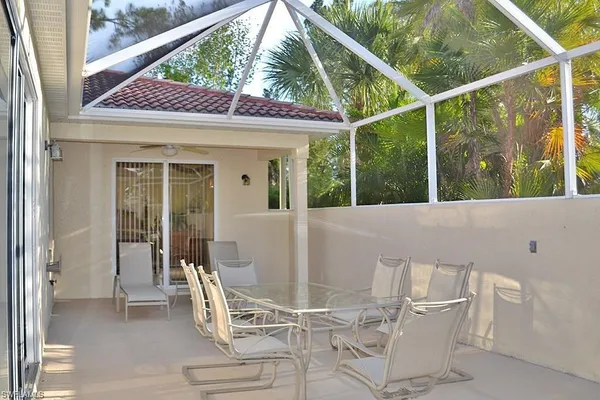 a view of a patio with a table and chairs