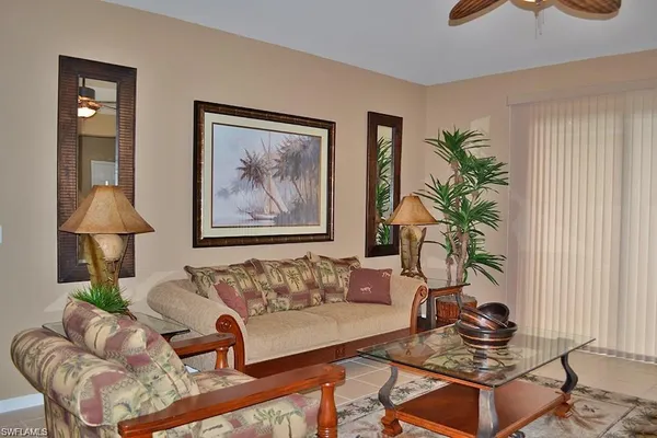 a living room with furniture and a potted plant