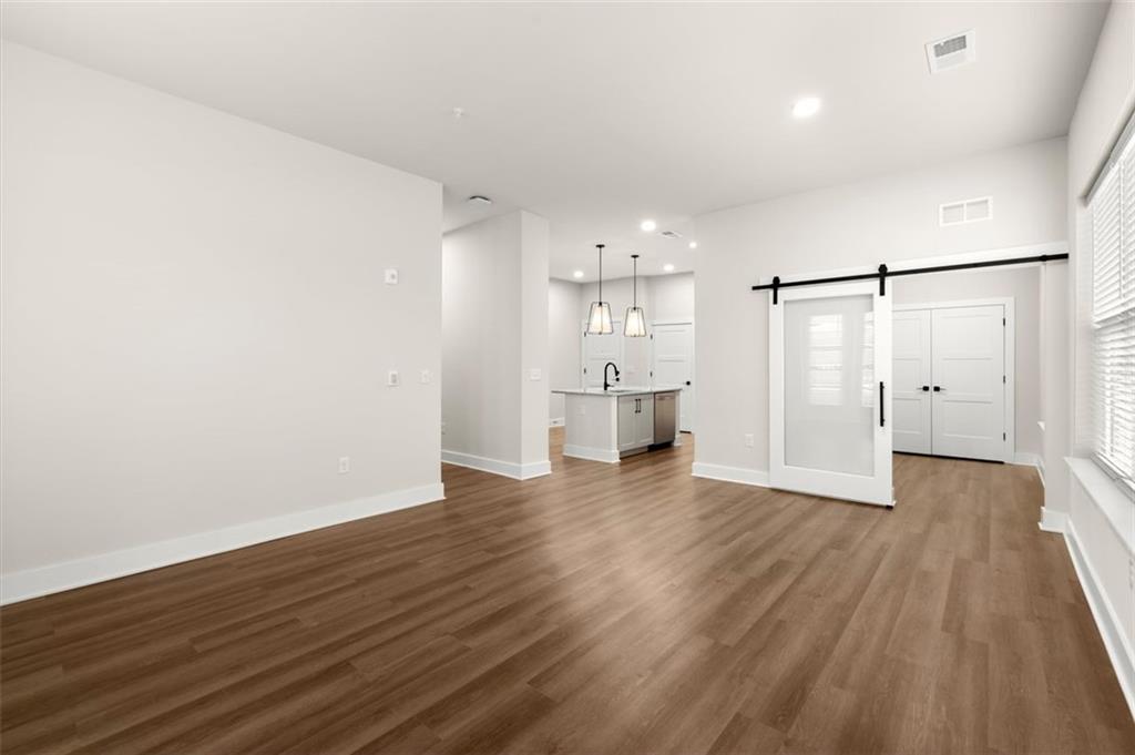 2648 Sandy Plains Road, Unit 301 Marietta, GA 30062 - Photo 11 of 46 a view of empty room with wooden floor and window