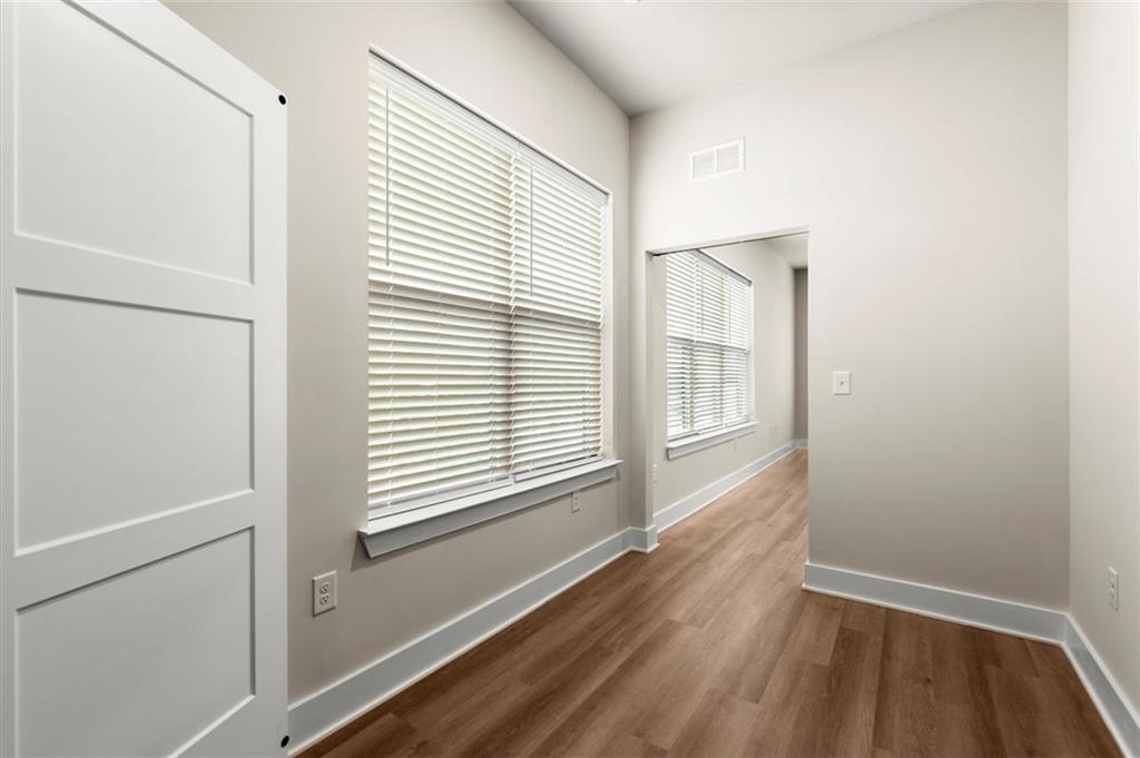 2648 Sandy Plains Road, Unit 301 Marietta, GA 30062 - Photo 15 of 46 a view of an empty room with a window and wooden floor
