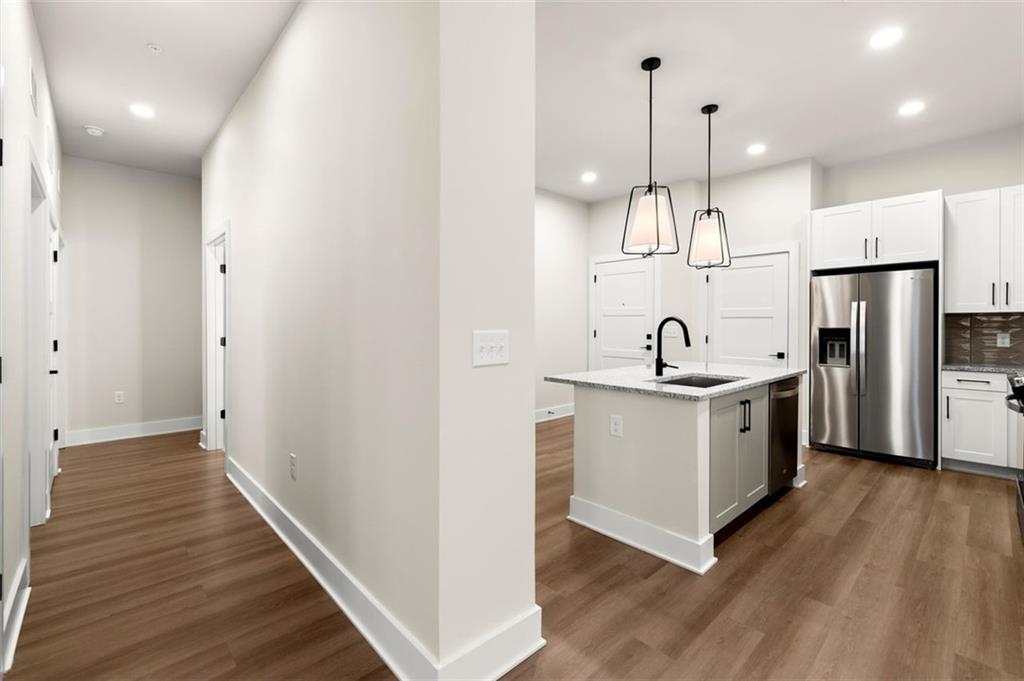 2648 Sandy Plains Road, Unit 301 Marietta, GA 30062 - Photo 17 of 46 a kitchen with stainless steel appliances a refrigerator a sink and wooden floor
