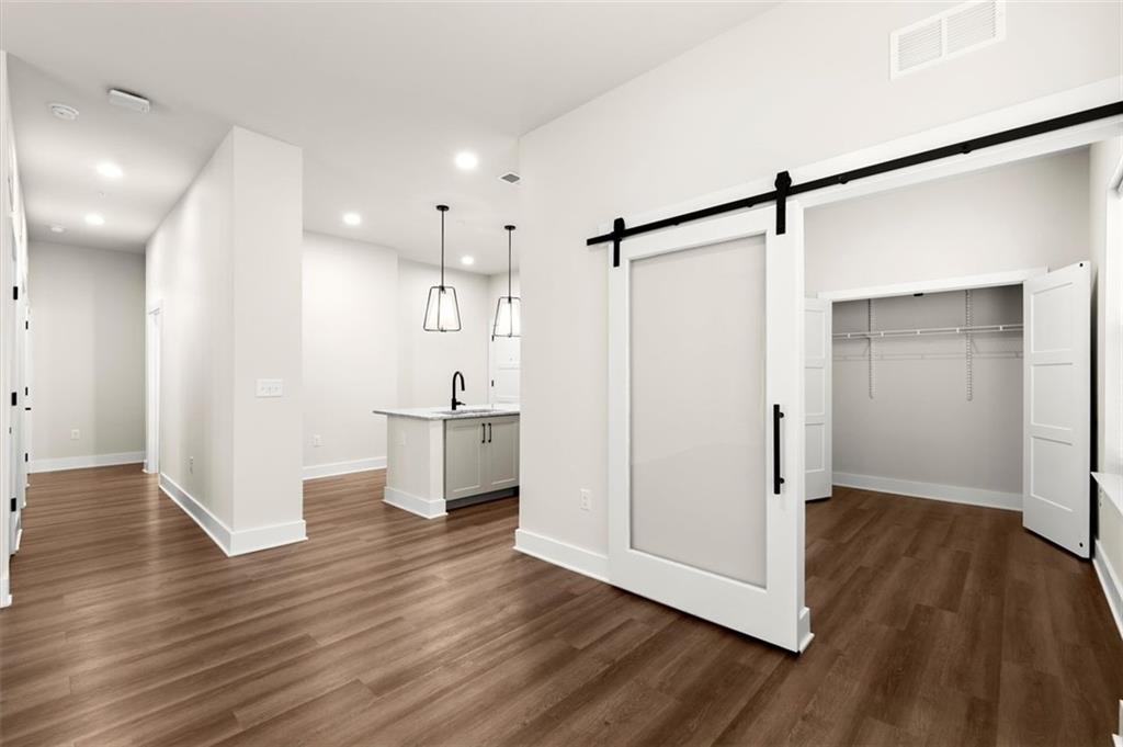 2648 Sandy Plains Road, Unit 301 Marietta, GA 30062 - Photo 18 of 46 a view of a kitchen with a white cabinet and wooden floor