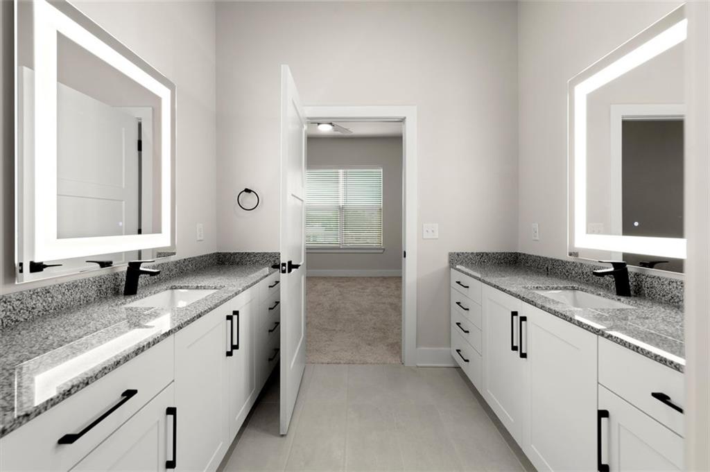 2648 Sandy Plains Road, Unit 301 Marietta, GA 30062 - Photo 23 of 46 a bathroom with a granite countertop sink and a mirror