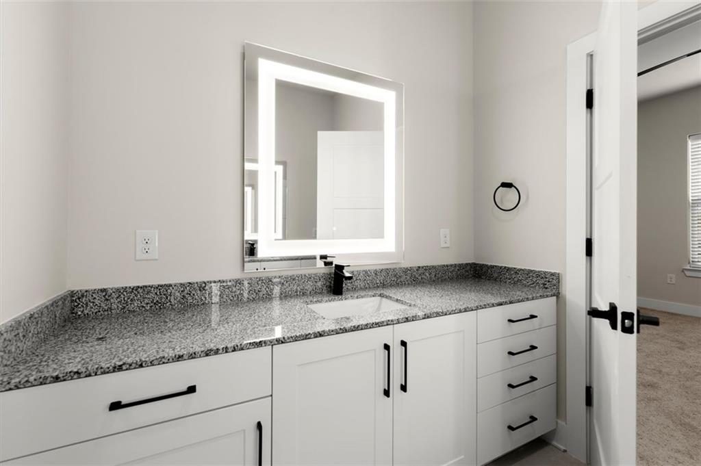 2648 Sandy Plains Road, Unit 301 Marietta, GA 30062 - Photo 25 of 46 a bathroom with a granite countertop double vanity sink and mirror