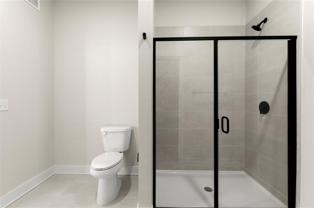 2648 Sandy Plains Road, Unit 301 Marietta, GA 30062 - Photo 27 of 46 a bathroom with a white toilet and a shower