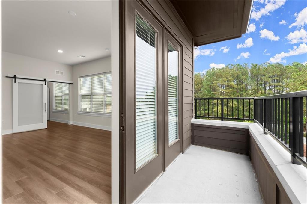 2648 Sandy Plains Road, Unit 301 Marietta, GA 30062 - Photo 34 of 46 a view of a room with wooden floor and iron stairs