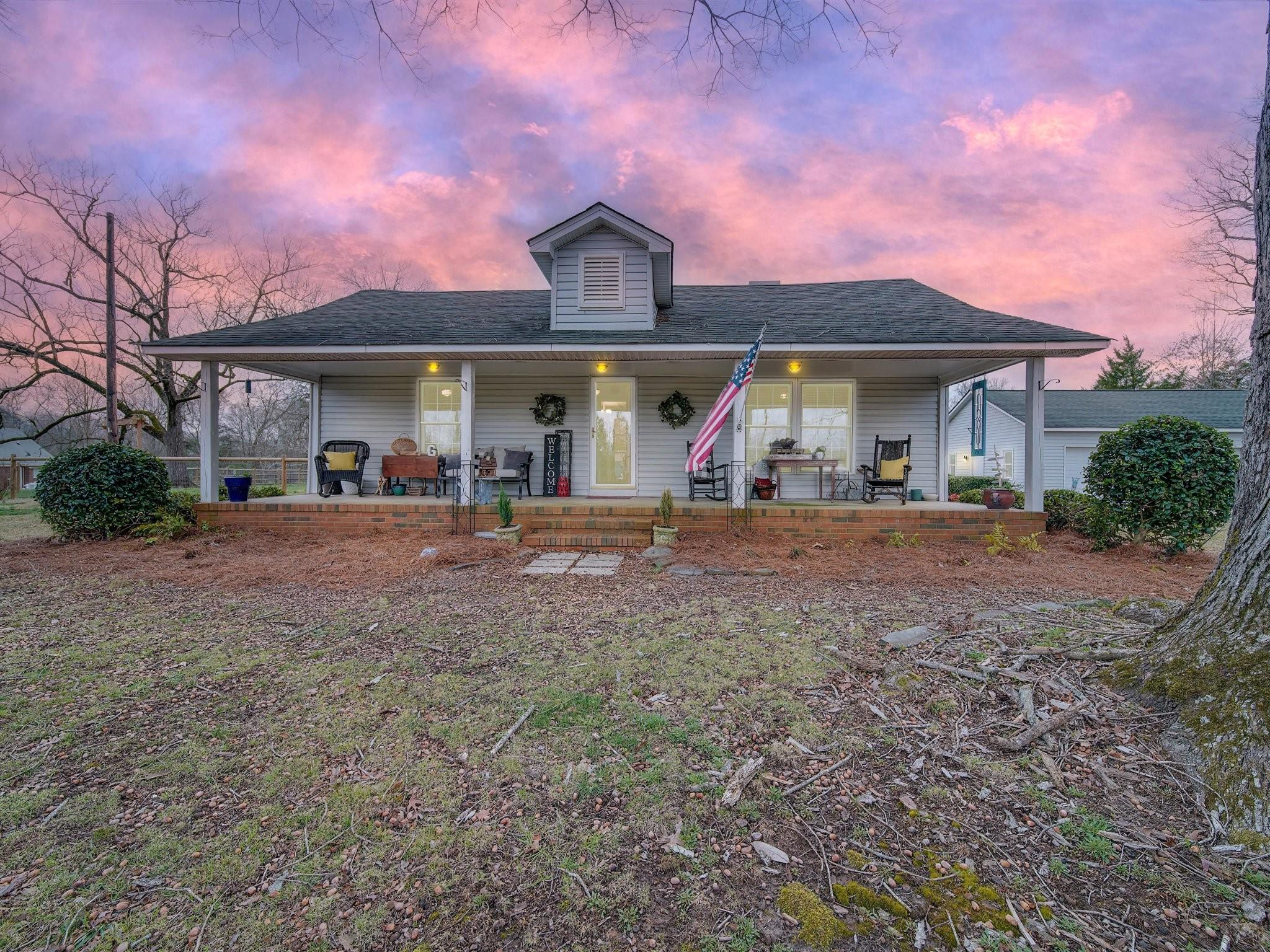 a front view of a house with a yard and entertaining space