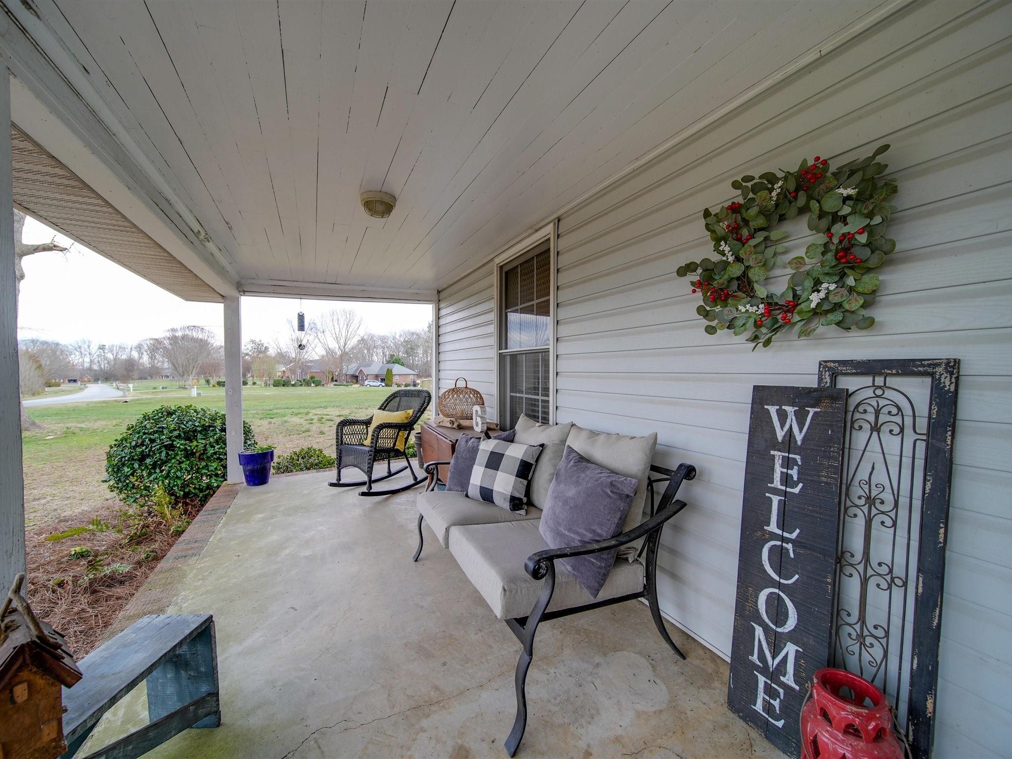 3410 Helms Pond Road Monroe, NC 28110 - Photo 11 of 35 a view of a patio with table and chairs potted plants with floor to ceiling window