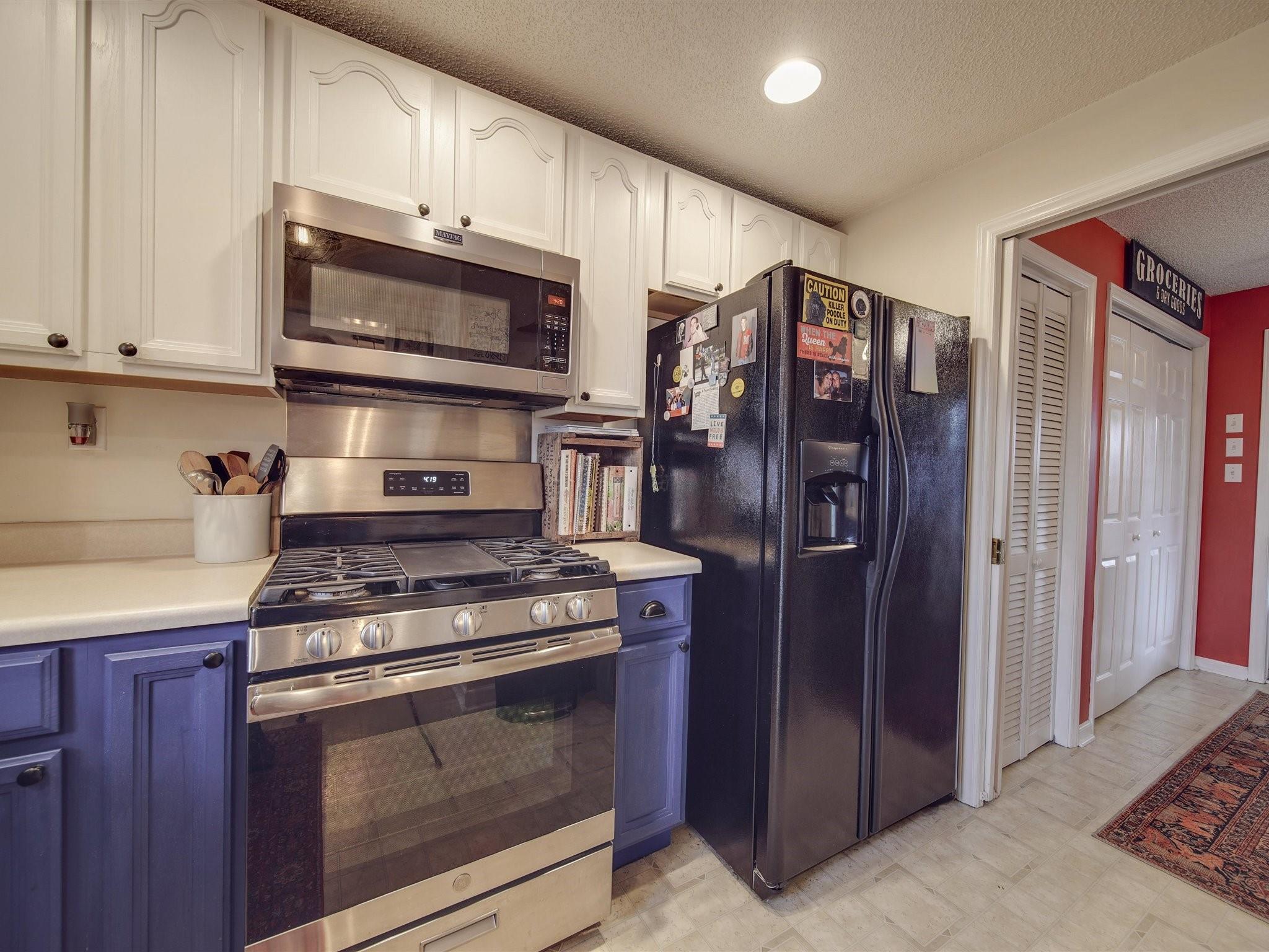 3410 Helms Pond Road Monroe, NC 28110 - Photo 22 of 35 a kitchen with stainless steel appliances granite countertop a stove a refrigerator and a microwave