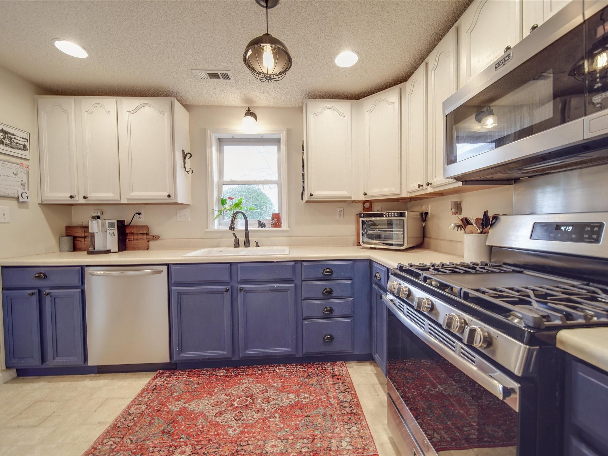3410 Helms Pond Road Monroe, NC 28110 - Photo 23 of 35 a kitchen with stainless steel appliances granite countertop a stove a sink and a refrigerator