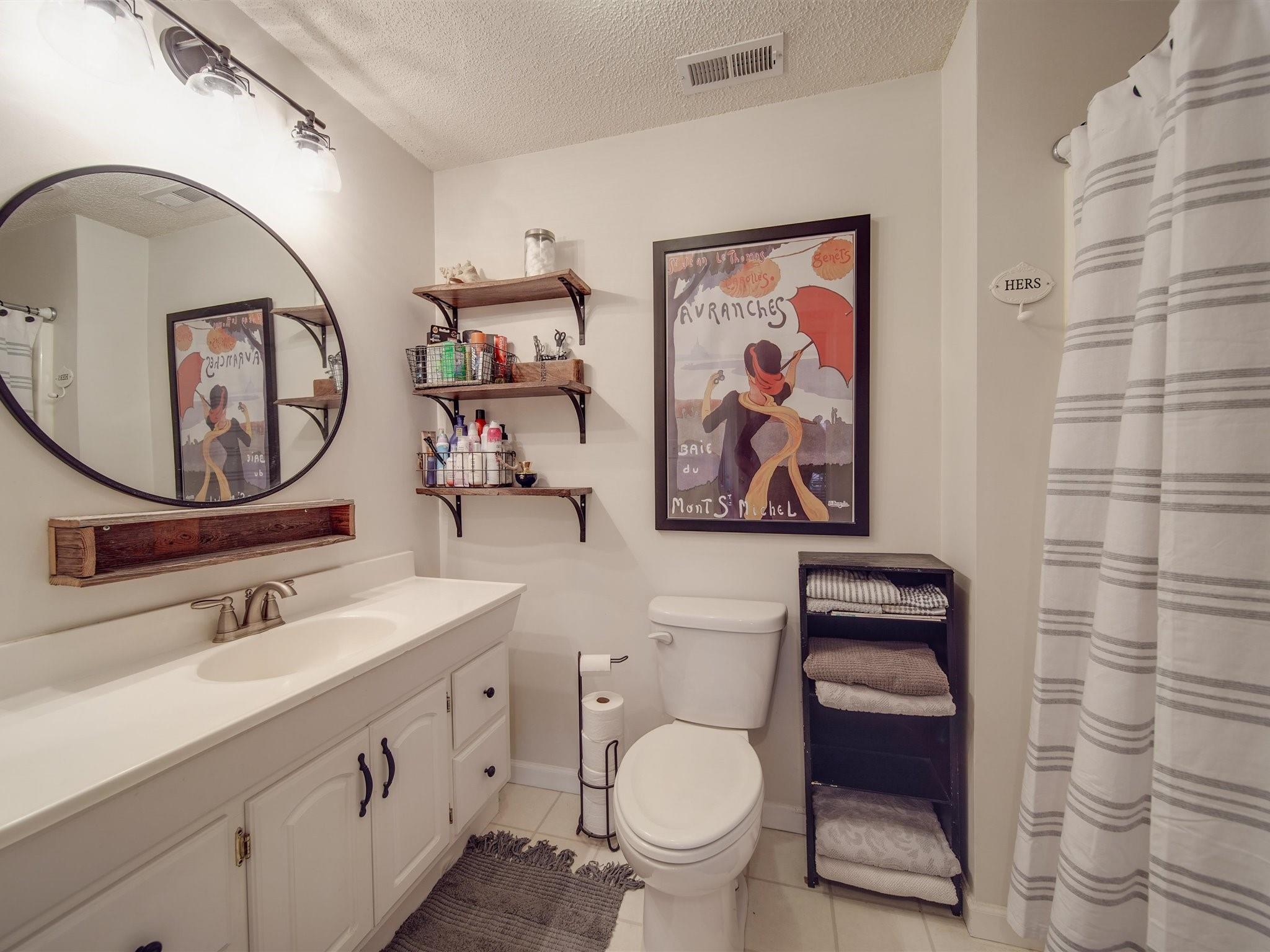 3410 Helms Pond Road Monroe, NC 28110 - Photo 31 of 35 a bathroom with a toilet a sink and mirror