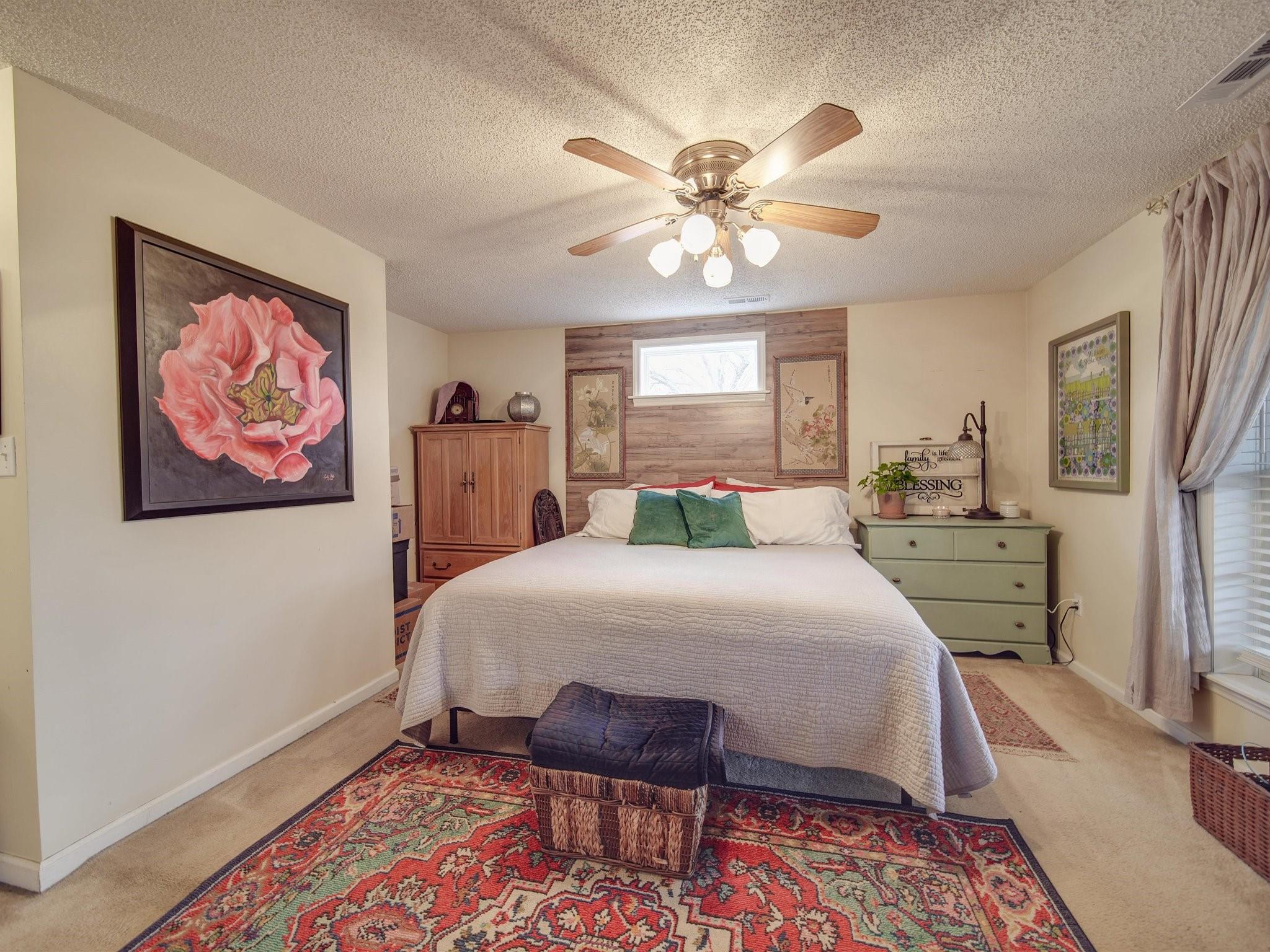 3410 Helms Pond Road Monroe, NC 28110 - Photo 33 of 35 a bedroom with a bed and a chandelier