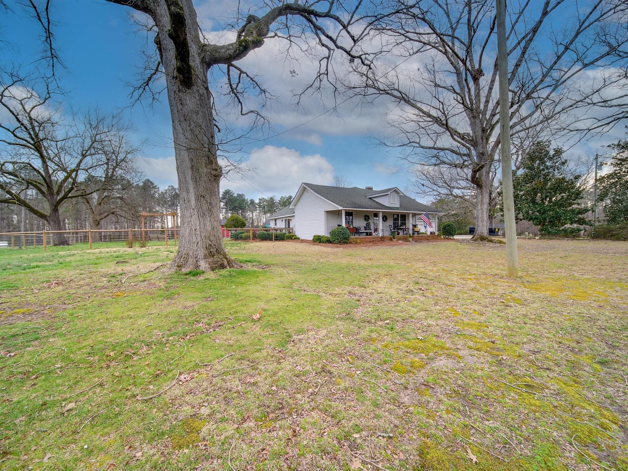 3410 Helms Pond Road Monroe, NC 28110 - Photo 8 of 35 a view of a yard with a house and large trees