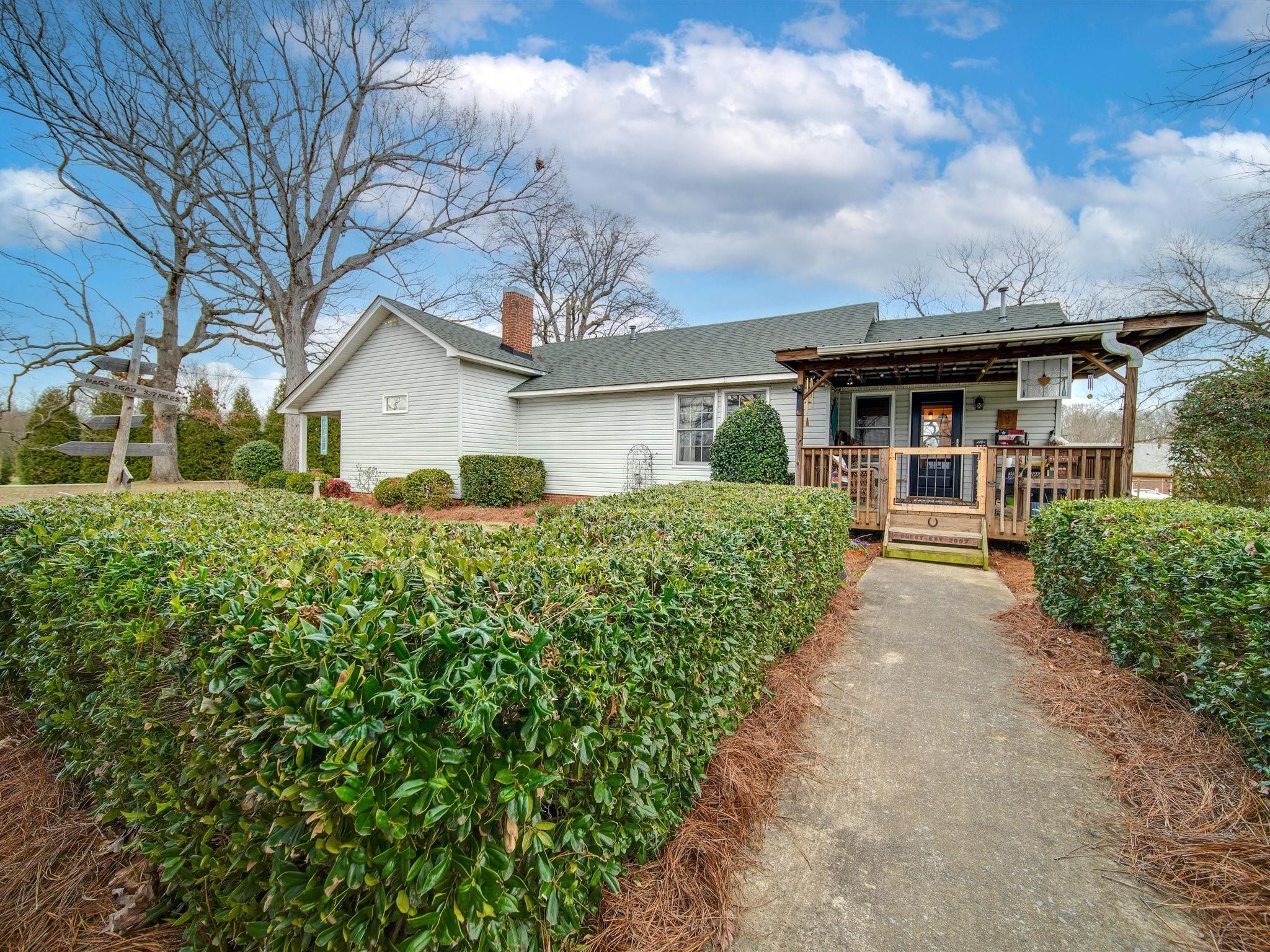 3410 Helms Pond Road Monroe, NC 28110 - Photo 10 of 35 a front view of a house with a garden