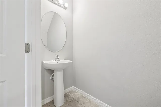 a bathroom with a sink a mirror and toilet
