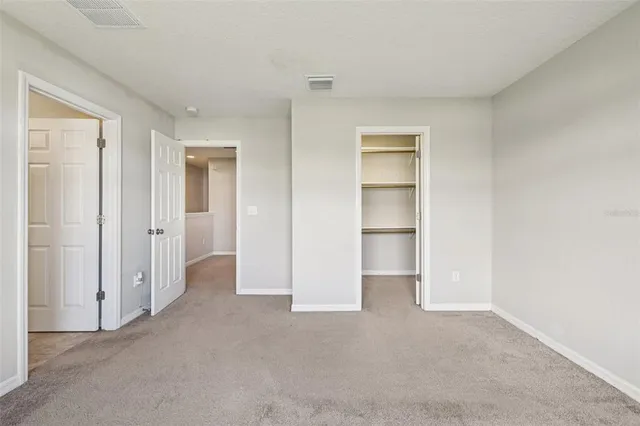 a view of an empty room and closet area