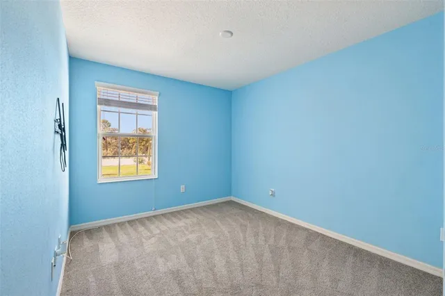 a view of an empty room and a window