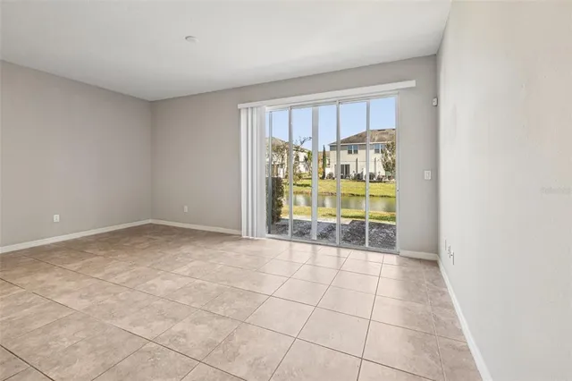 a view of empty room with a fireplace and outdoor view