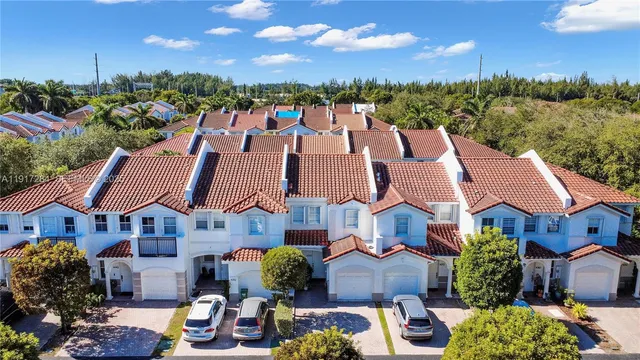 a aerial view of multiple houses with a yard