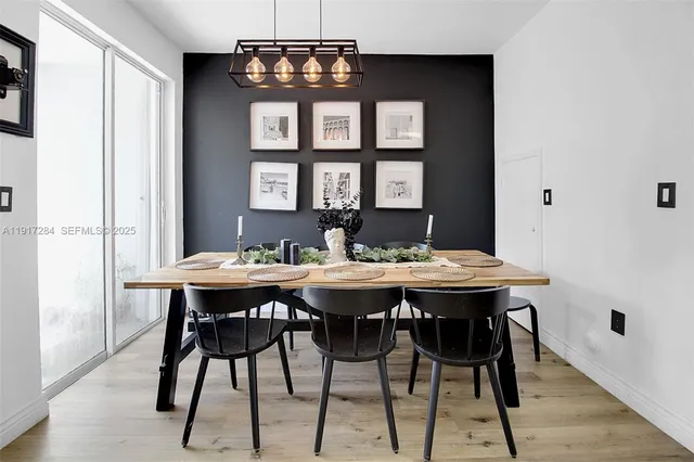 a view of a dining room with a table and chairs