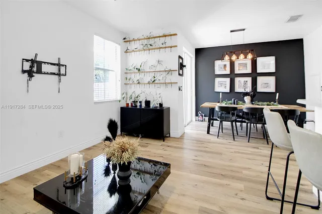 a view of a dining room with furniture and chandelier