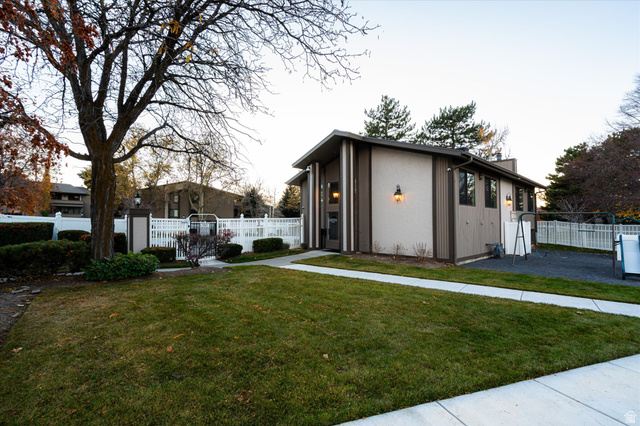 888 East 6895 South Midvale, UT 84047 - Photo 23 of 54 Nicely landscaped common areas with sidewalks and green space, creating a peaceful, park-like setting throughout the community.